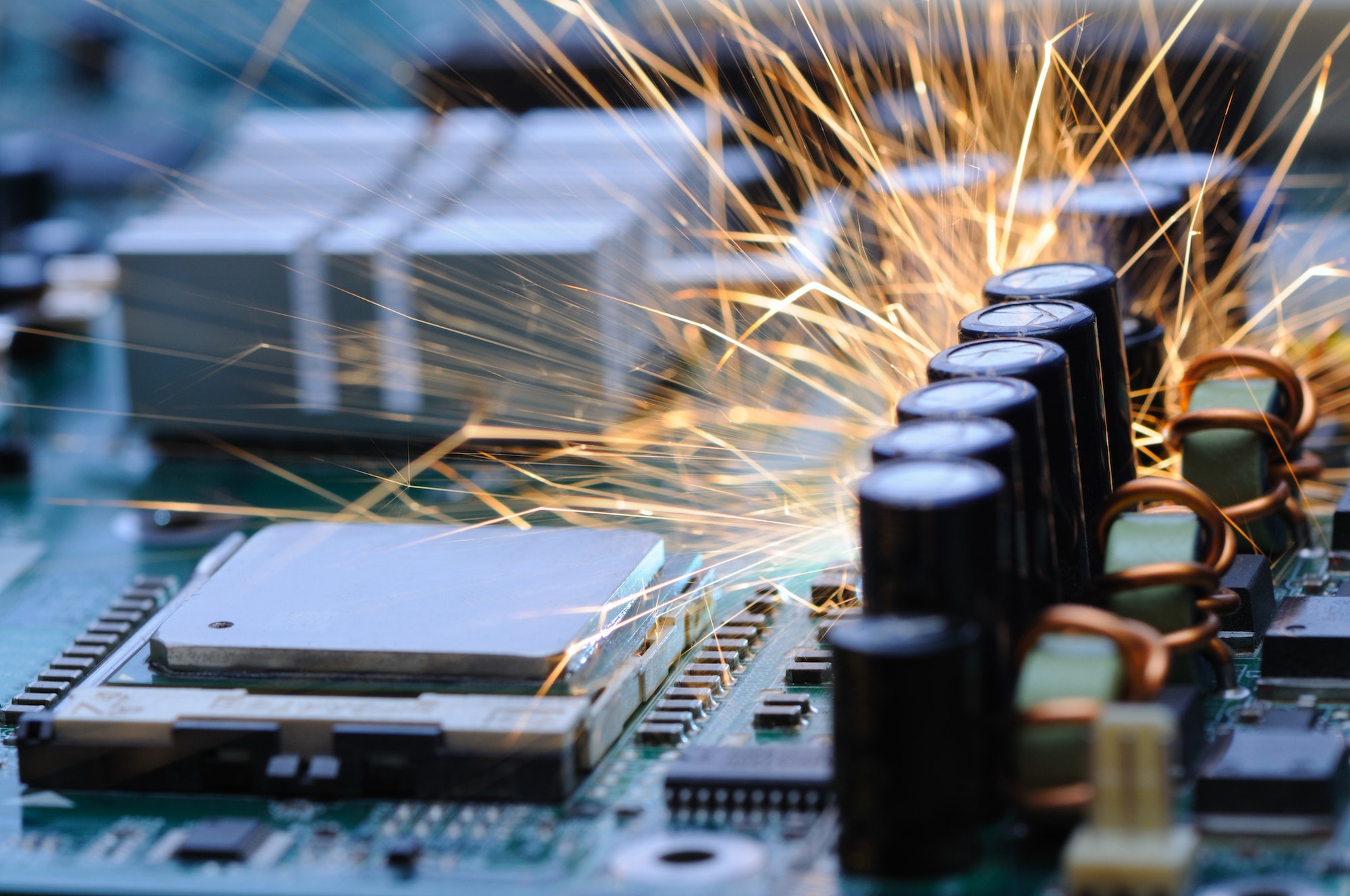 Burning sparks fly from a circuit chip